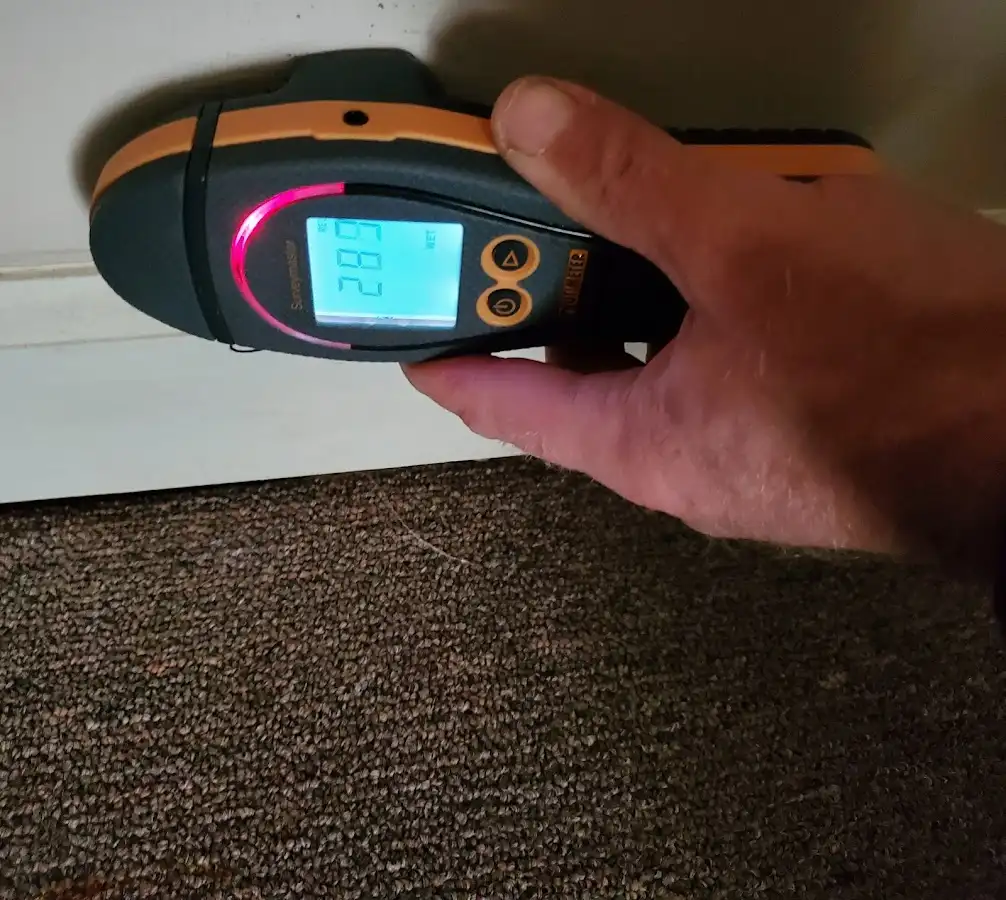 Moisture detection at baseboard during Storm Damage Restoration in Stallings